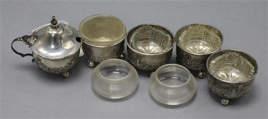 A late Victorian five piece condiment set with associated glass liners and tow other liners.
